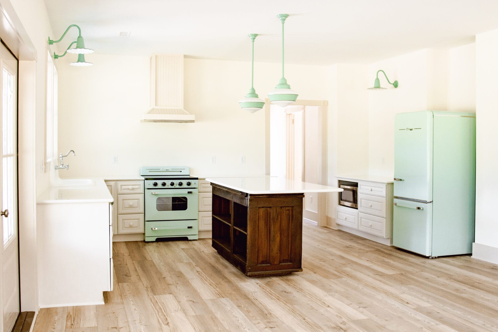 new old cottage kitchen with retro mint green appliance and vintage inspired jadeite green lights