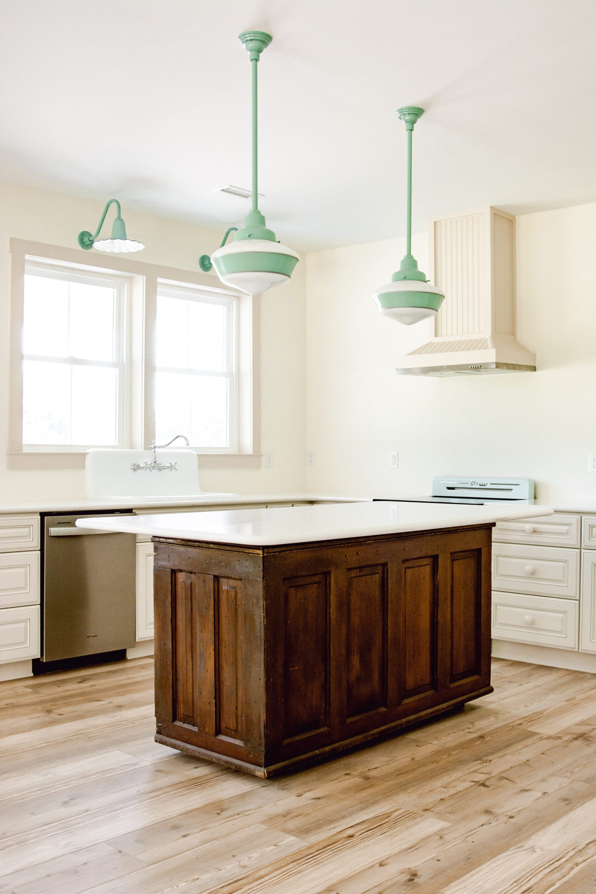 antique general store counter used as a cottage kitchen island with white quartz countertop