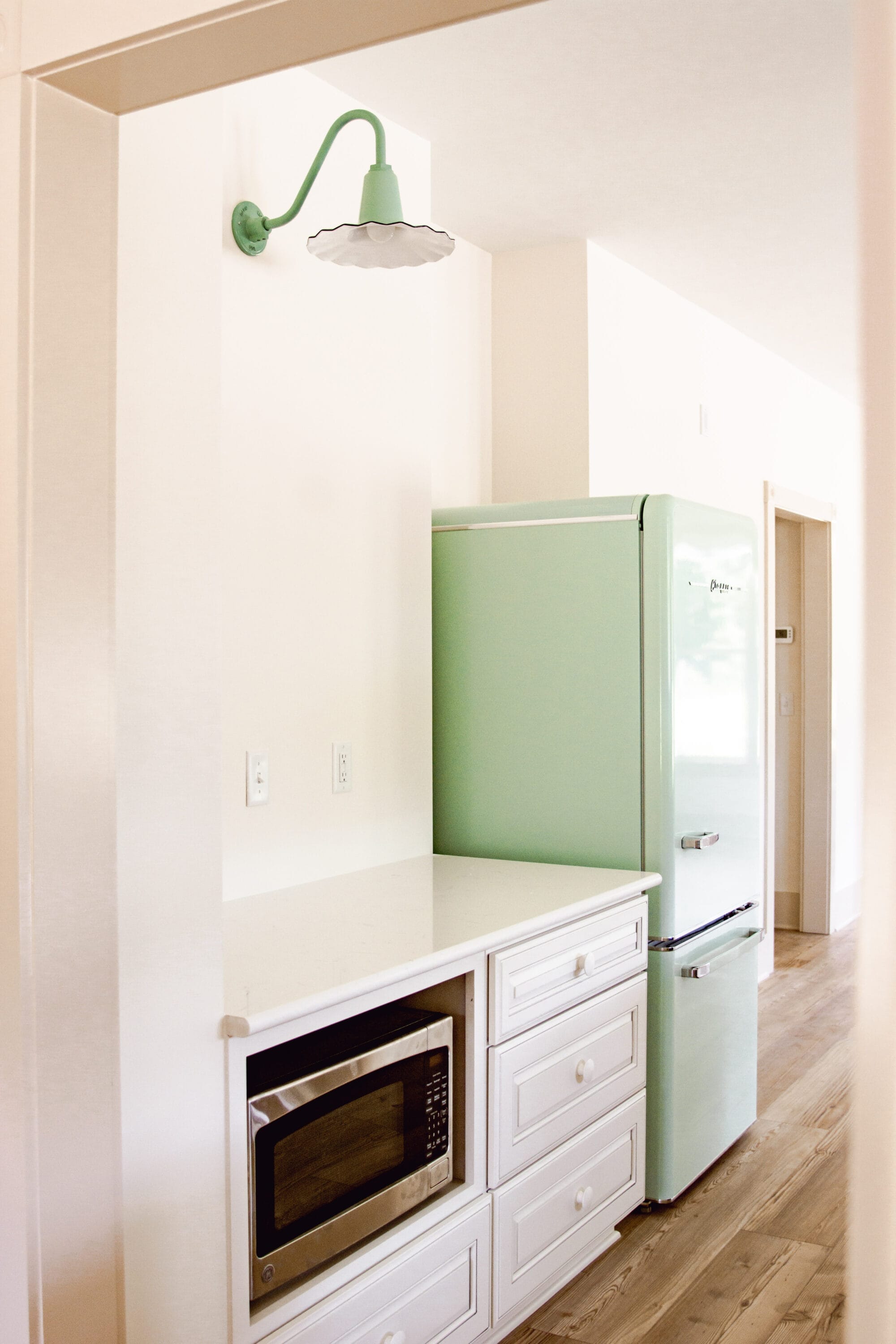 jadeite green seaside gooseneck sconce light from barn light electric and a mint green fridge