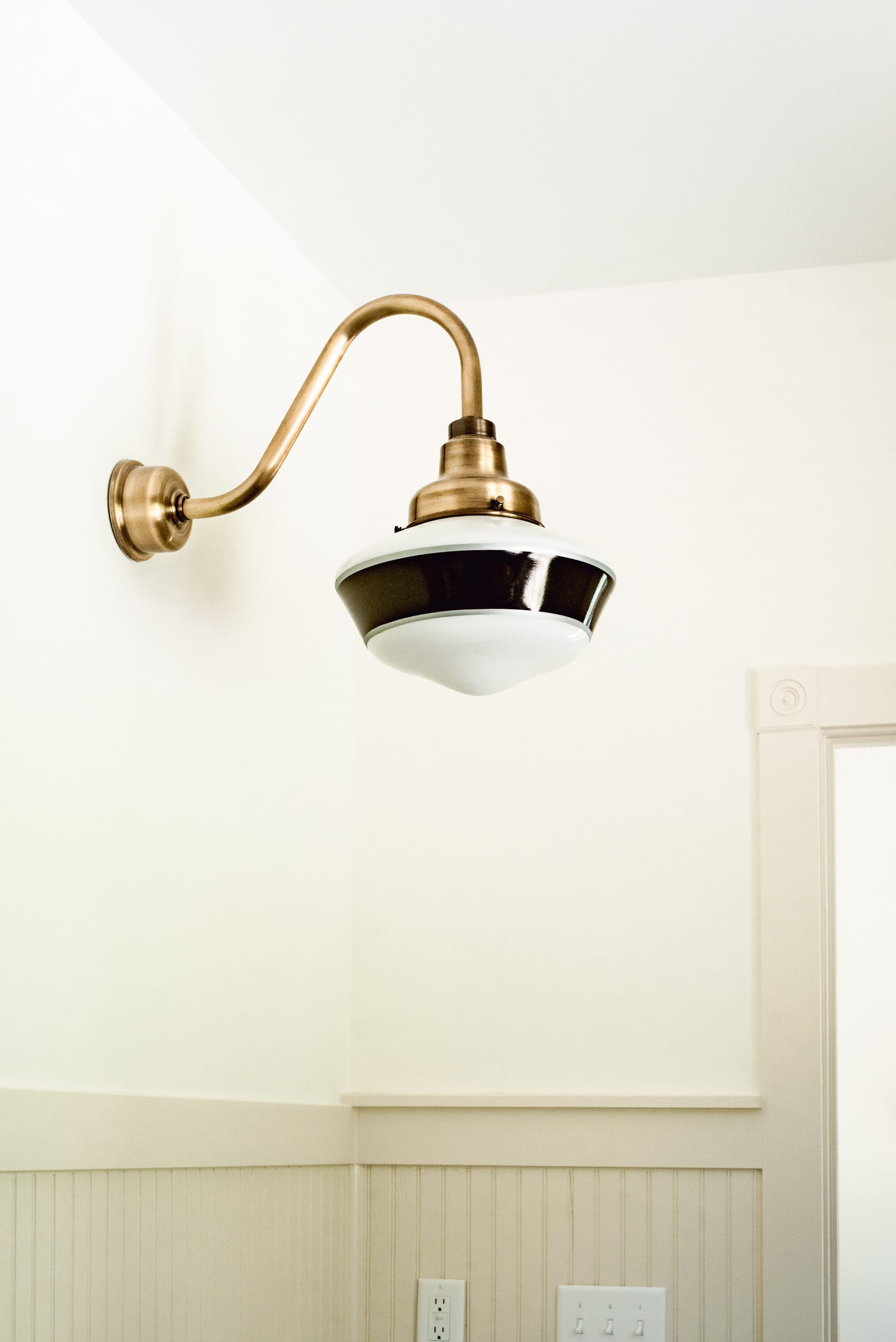 vintage inspired black white and antique brass schoolhouse light for a cottage bathroom