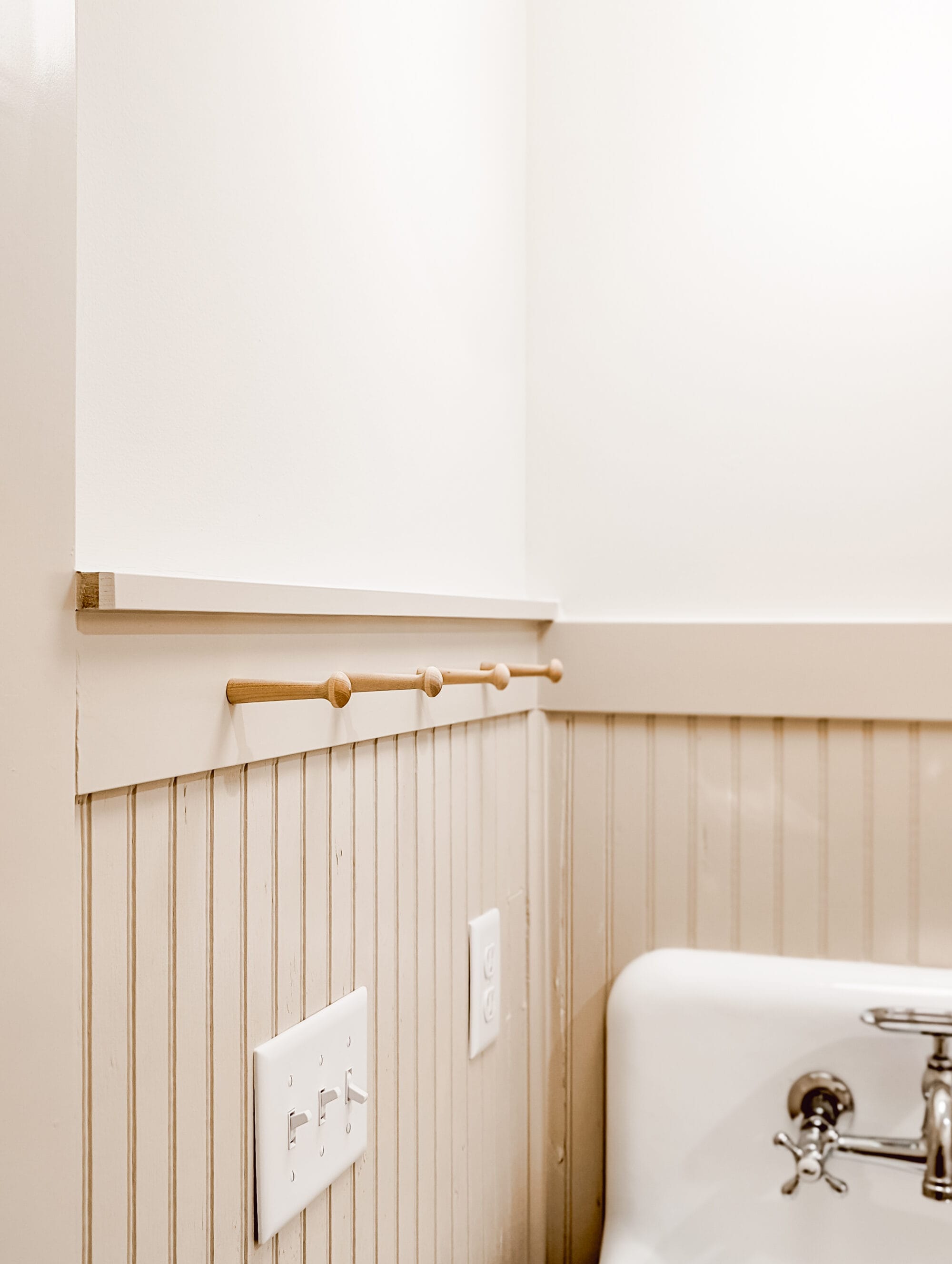 peg hooks by the bathroom sink