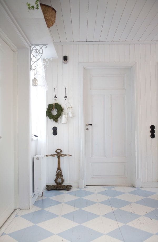 blue and white diamond pattern painted on old wood floors