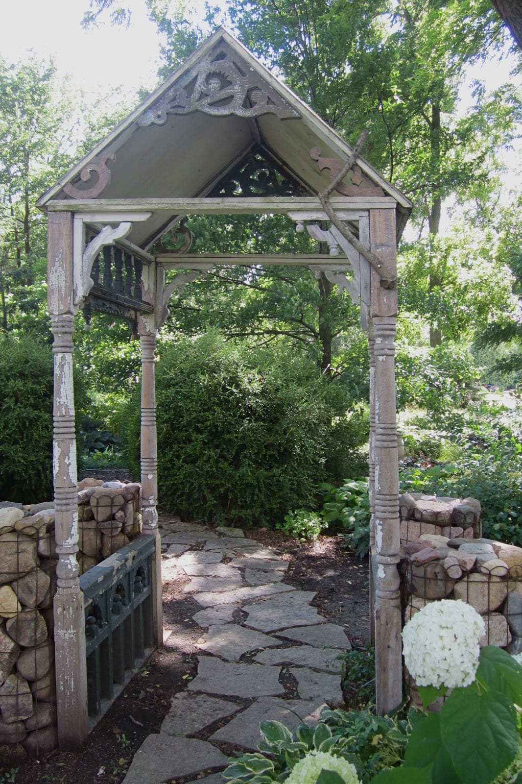 weathered wood porch post garden arbor with a mix of antique corbels added in the corners