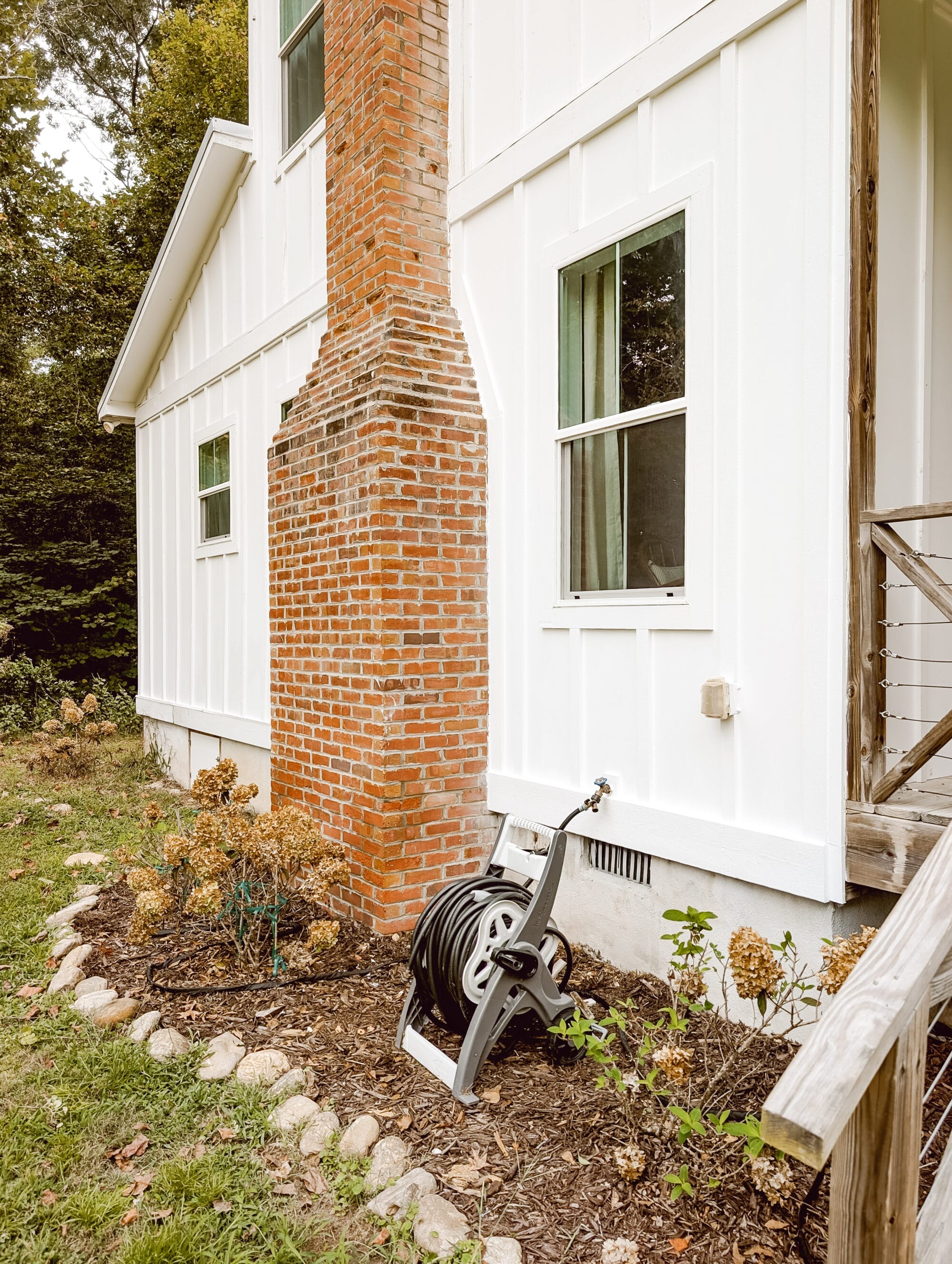 freshly painted white board and batten siding on an old farmhouse