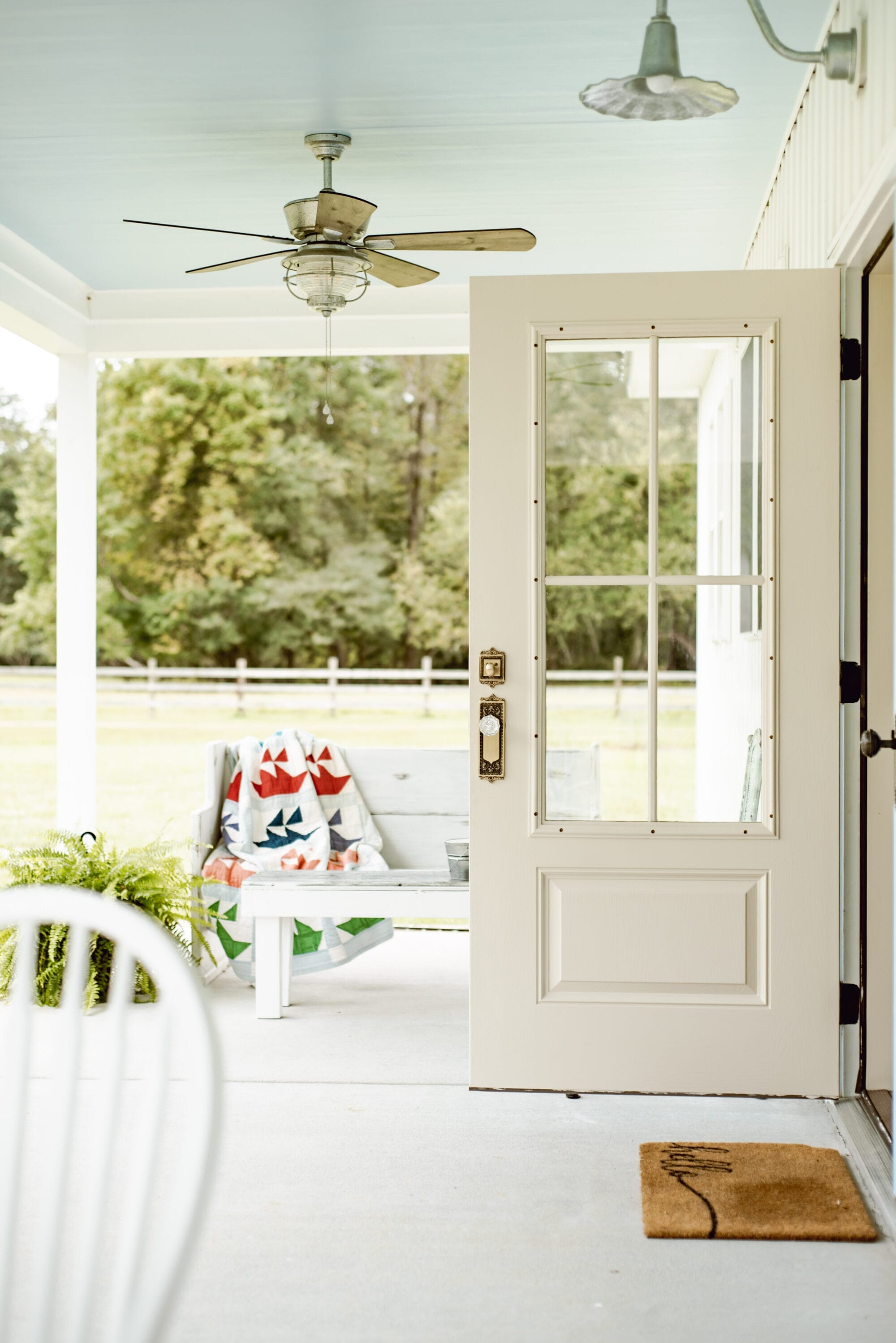 vintage cottage porch with haint blue ceilings 3/4 lite french doors with vintage-inspired door knobs from Nostalgic Warehouse