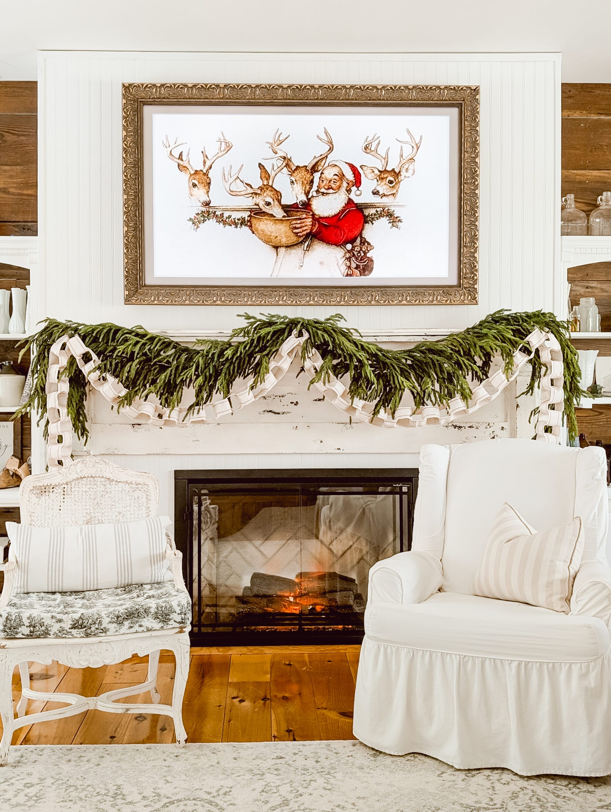layered norfolk pine and ribbon chain Christmas garlands on the fireplace