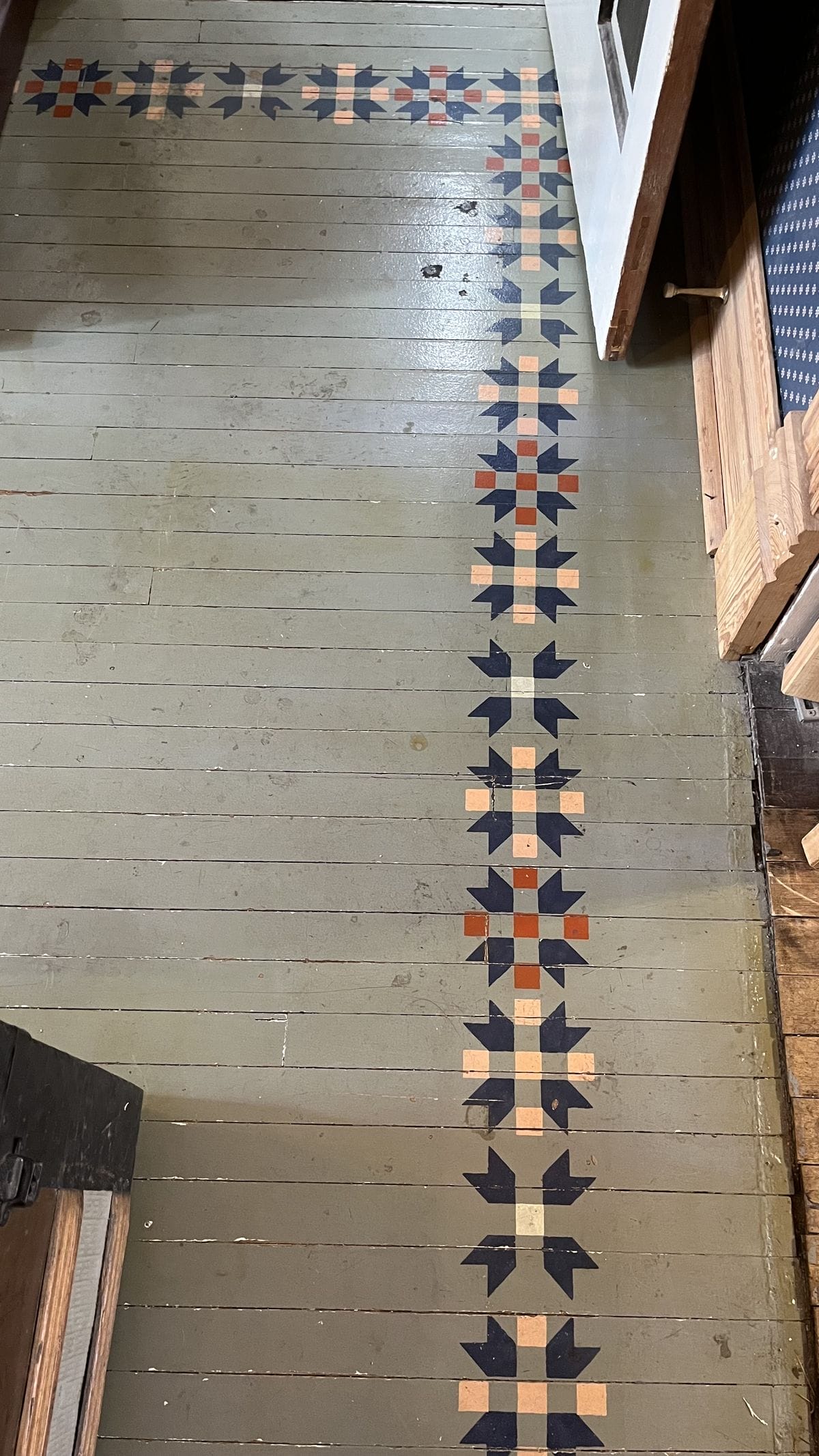 blue painted wood floors with a quilt block border
