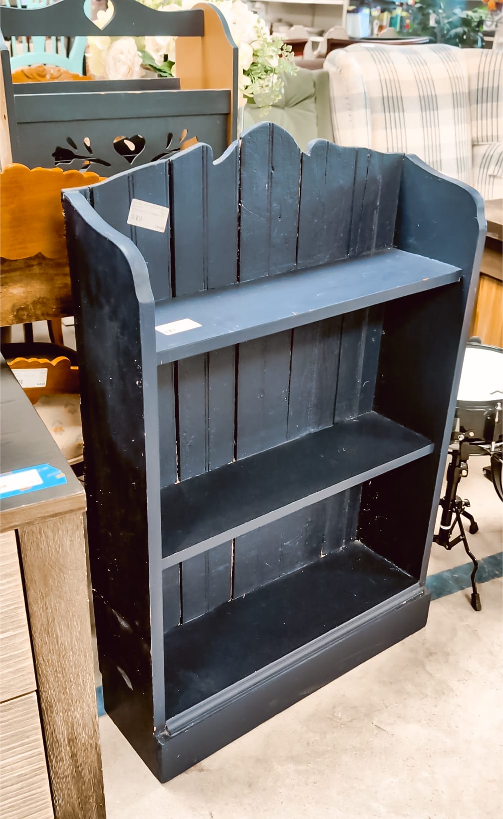 navy blue vintage children's bookshelf at a thrift store